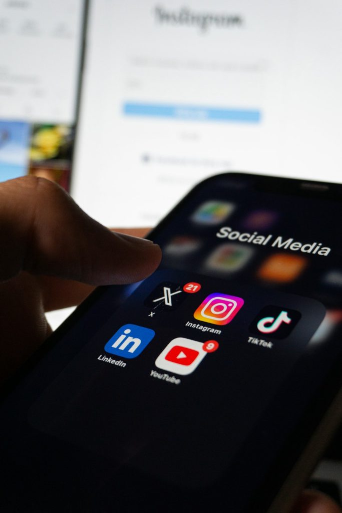 a-person-holding-a-smart-phone-with-social-media-on-the-screen-0cpyfssuisc social media apps on the phone in dark ambience