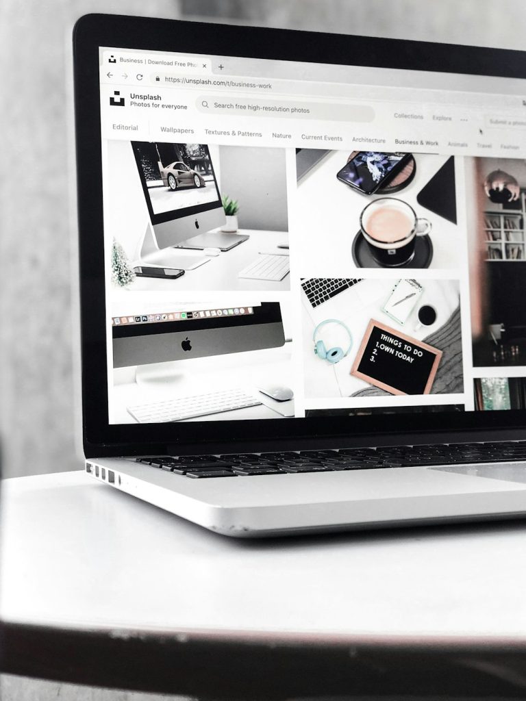 gray-and-black-laptop-computer-turned-on-displaying-photos-of-imac-and-coffee-8dj62bk38bi Unsplash has made me discover just how much I love taking pictures of tech products and for that, I’m grateful.